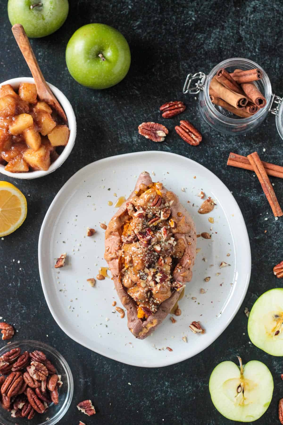 Finished recipe with sweet apple topping, nut butter, and chopped nuts.