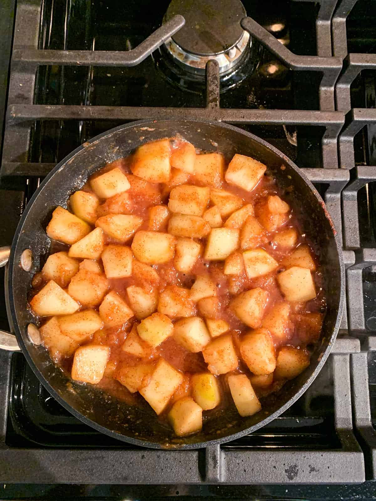 Diced apples simmering with cinnamon and maple syrup.