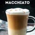 Apple crisp oatmilk macchiato in a glass topped with frothed milk and caramel drizzle.
