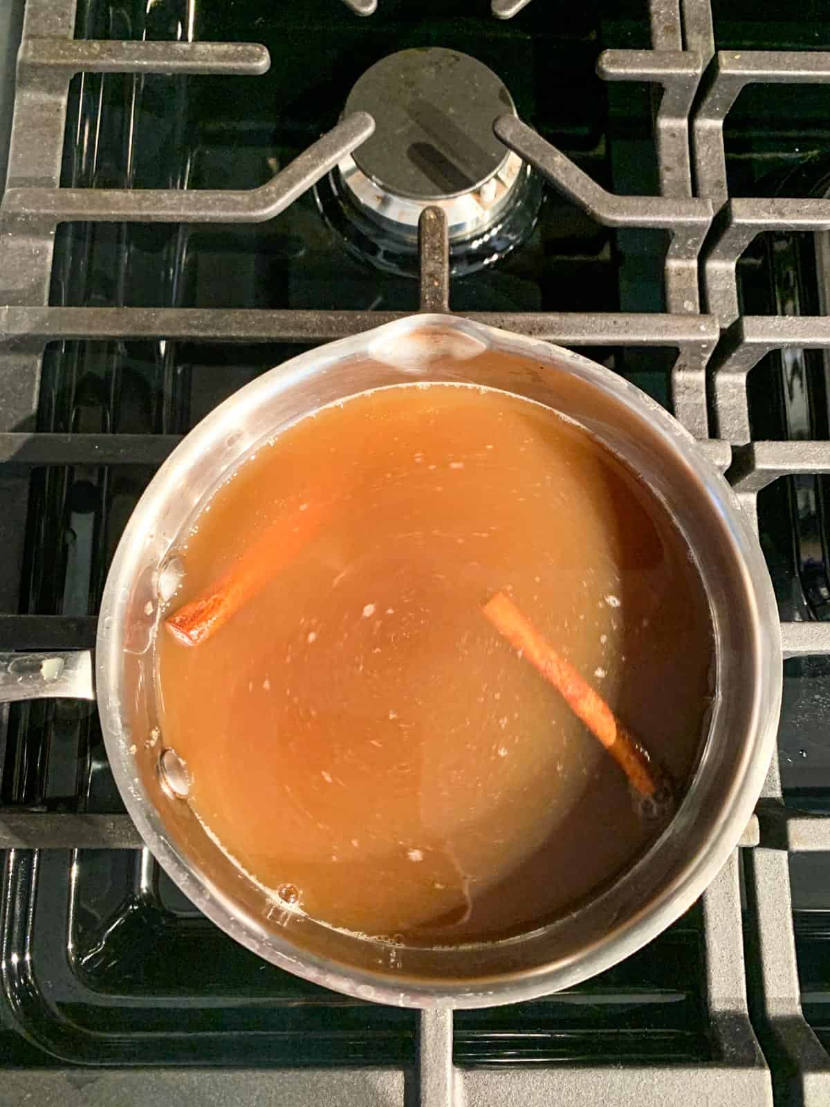 Apple cider brown sugar syrup ingredients in a pot.