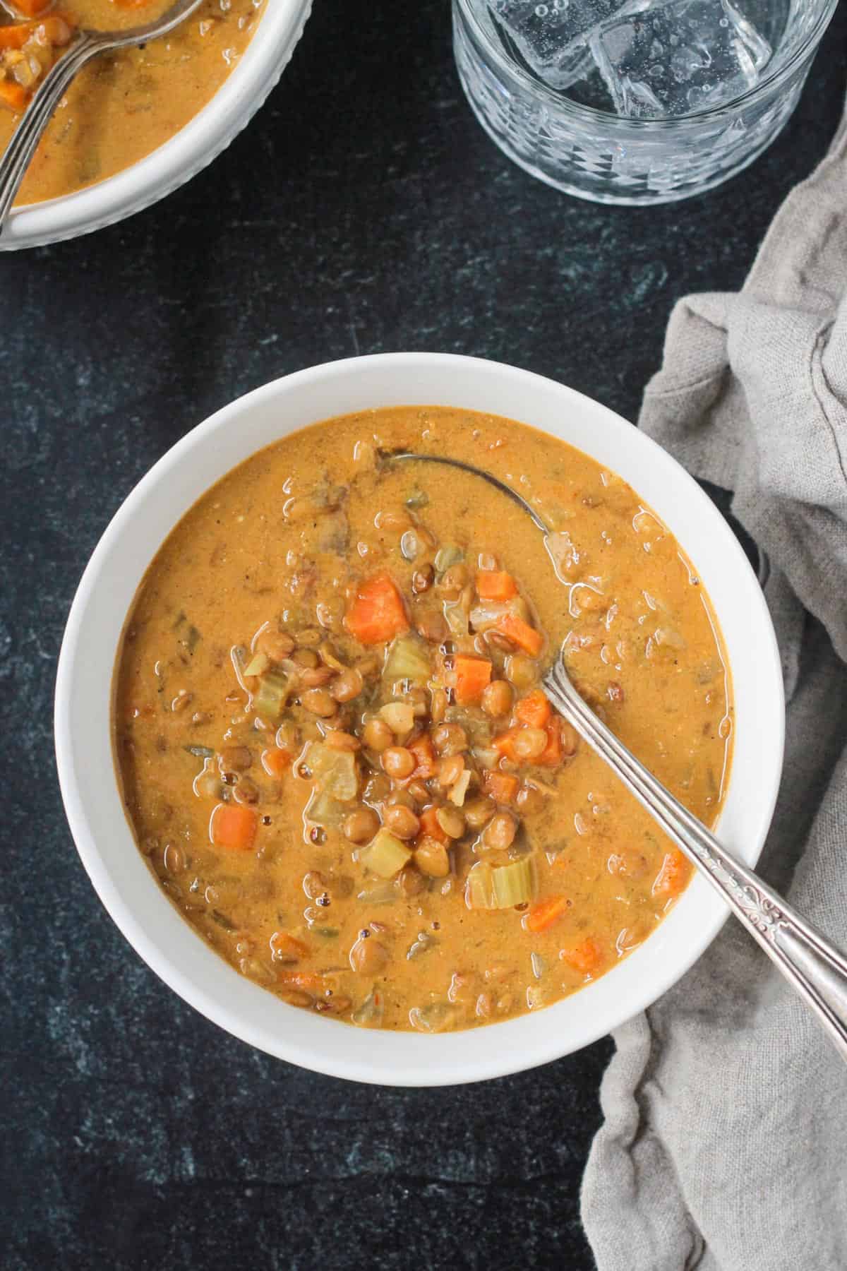 Overhead view of a bowl of curried carrot lentil soup.