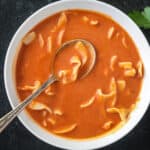 Spoon in a bowl of polish tomato soup.