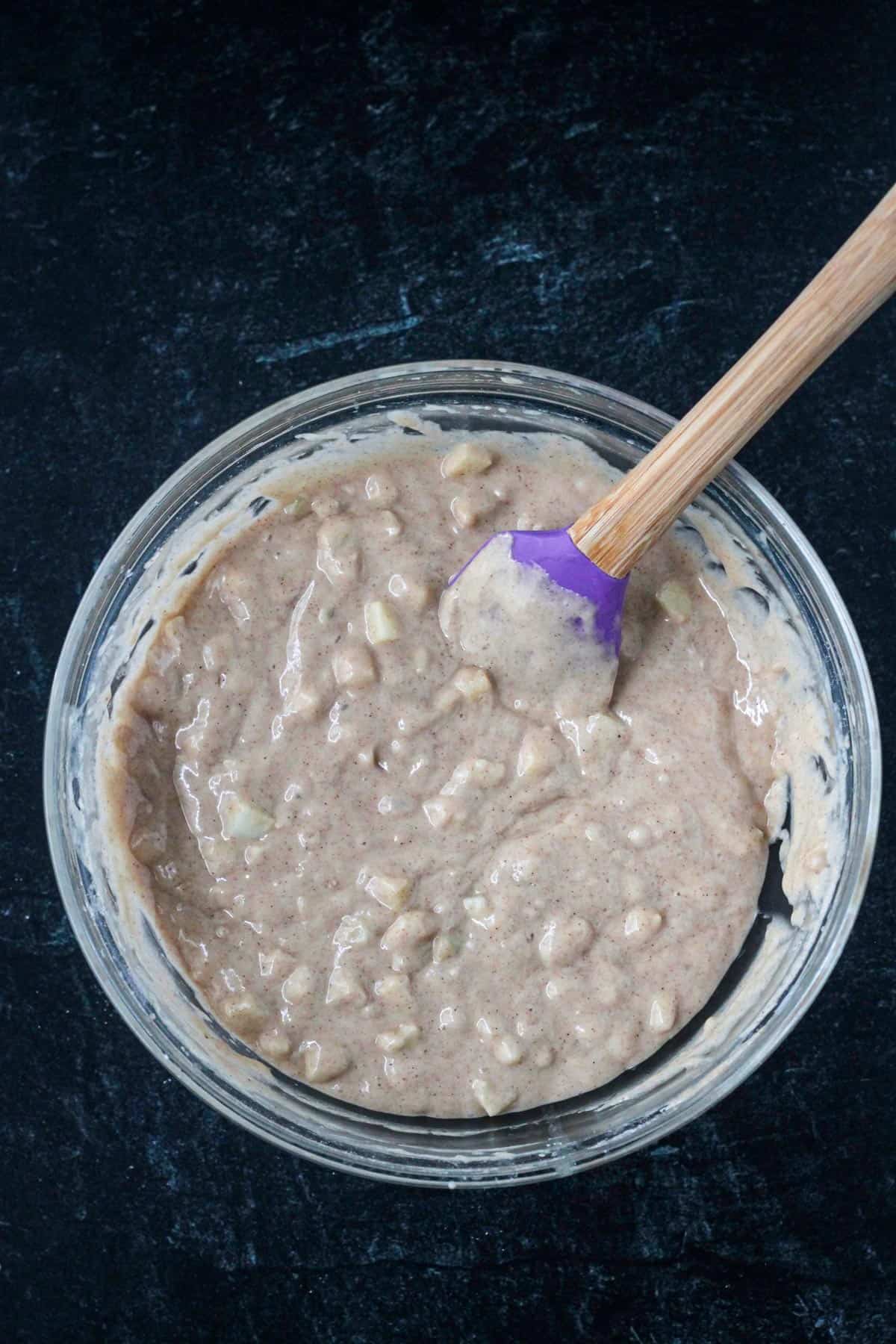 Vegan apple cake batter in a mixing bowl.
