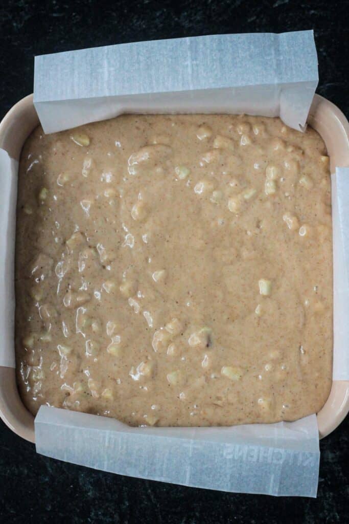 Raw cake batter in a square baking dish.
