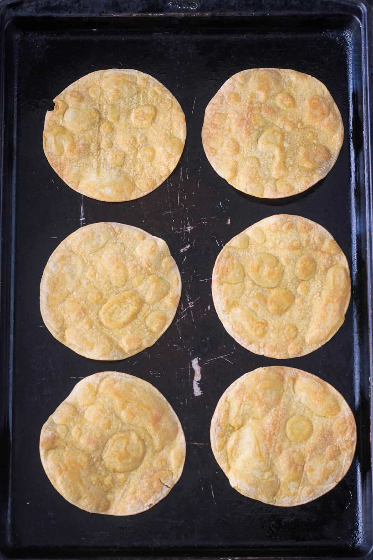 6 tortillas baked until crispy on a baking pan.