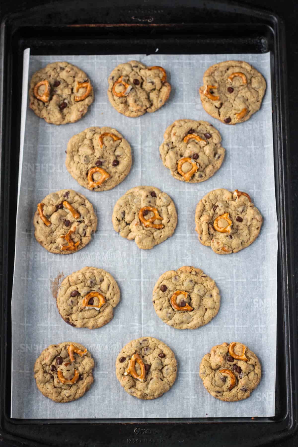 Baked cookies on a parchment lined cookie sheet.