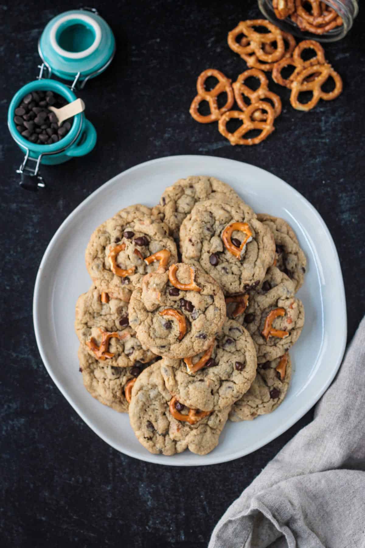 Pile of vegan chocolate chip cookies with pretzels on a plate.