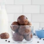 Edible brownie batter balls piled up in a small parfait glass.