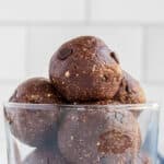 Edible brownie batter balls piled up in a small parfait glass.