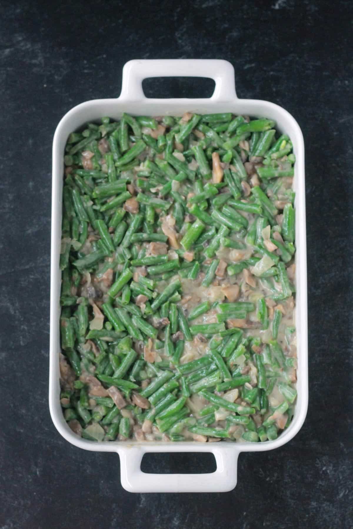 Green beans in sauce in a casserole dish.