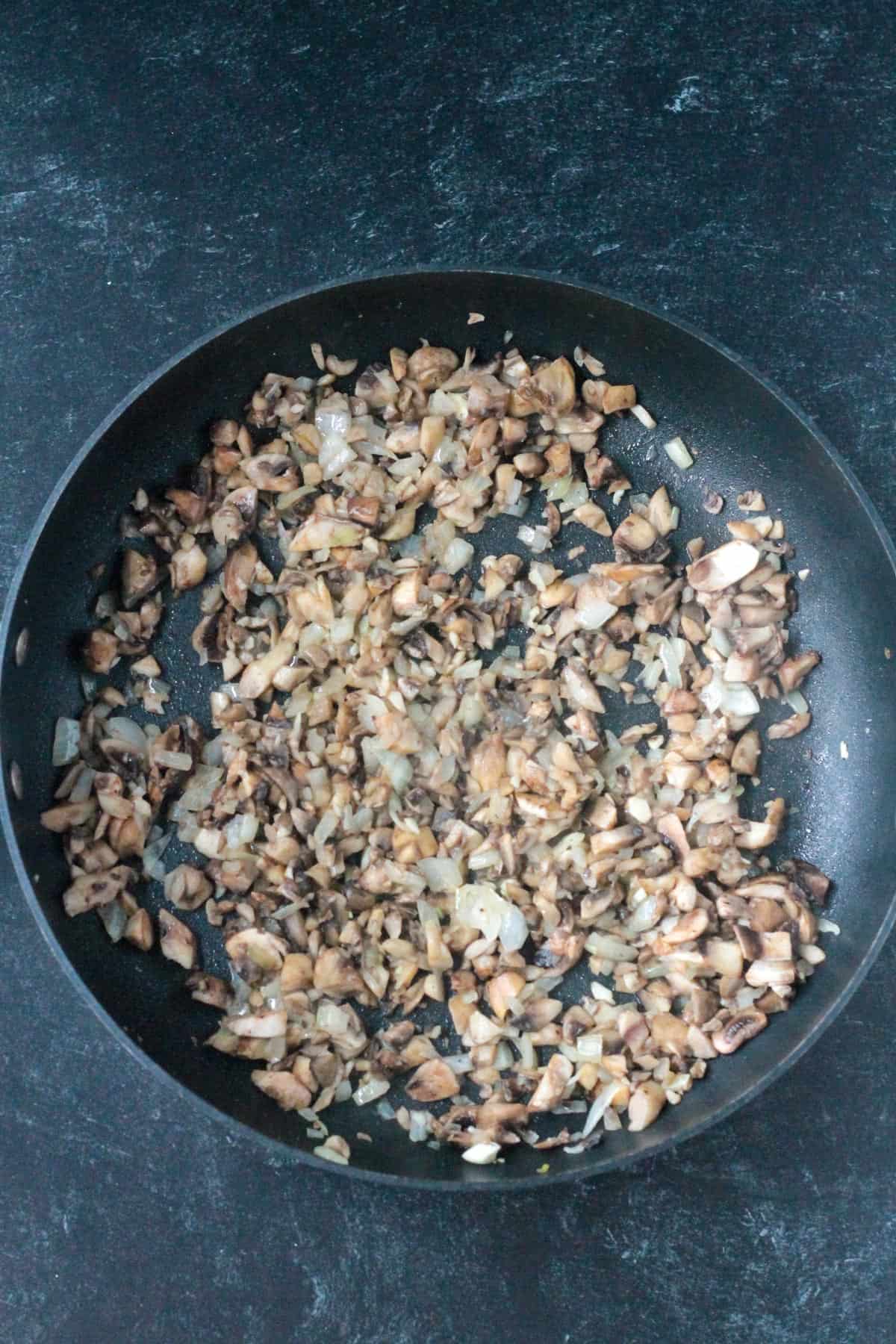 Cooked mushrooms in a skillet.