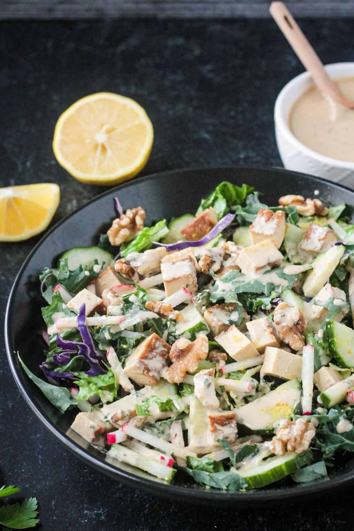Tahini dressing drizzled over the top of a salad.