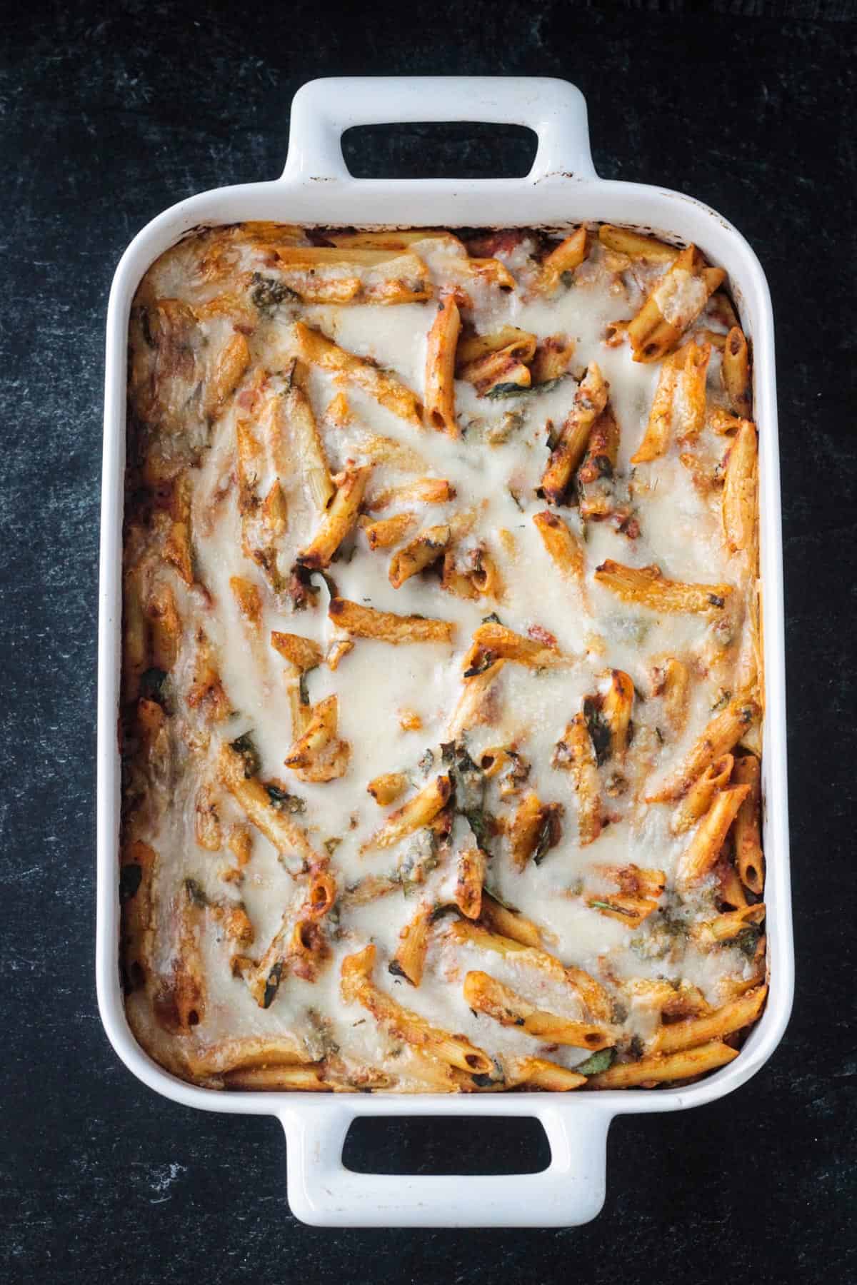 Vegan pasta baked right from the oven with melty cheese on top.