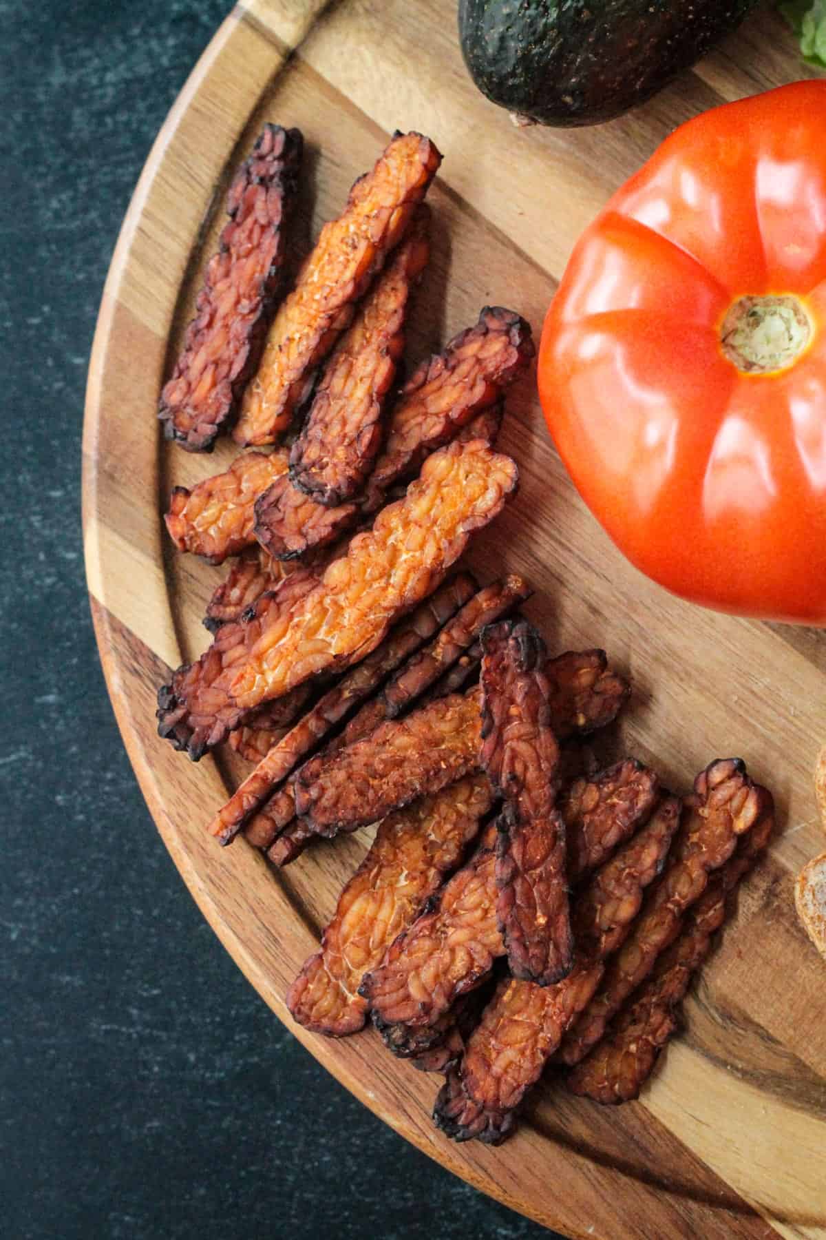 Close up of smokey tempeh bacon on a serving tray.