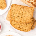 Slices of vegan oatmeal molasses bread on plates.