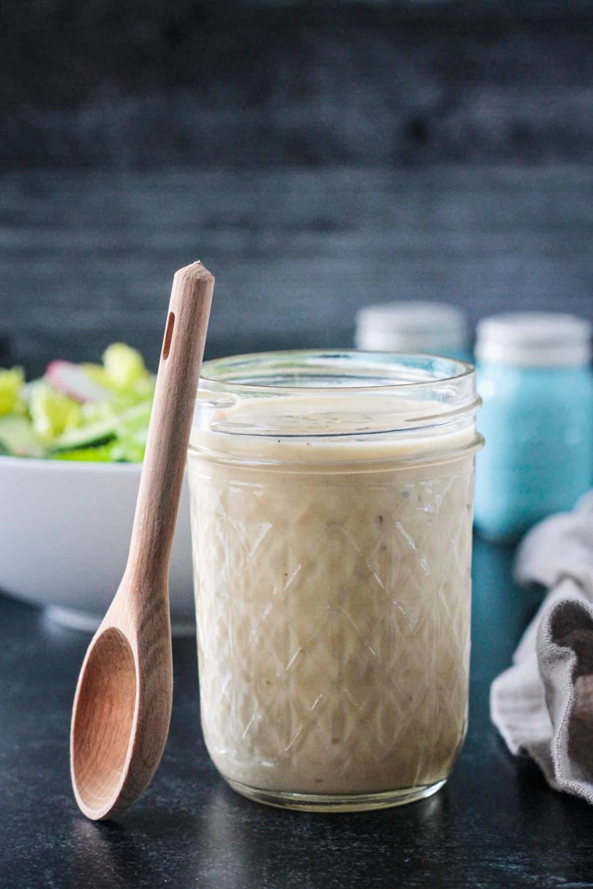 Small glass jar of dressing.