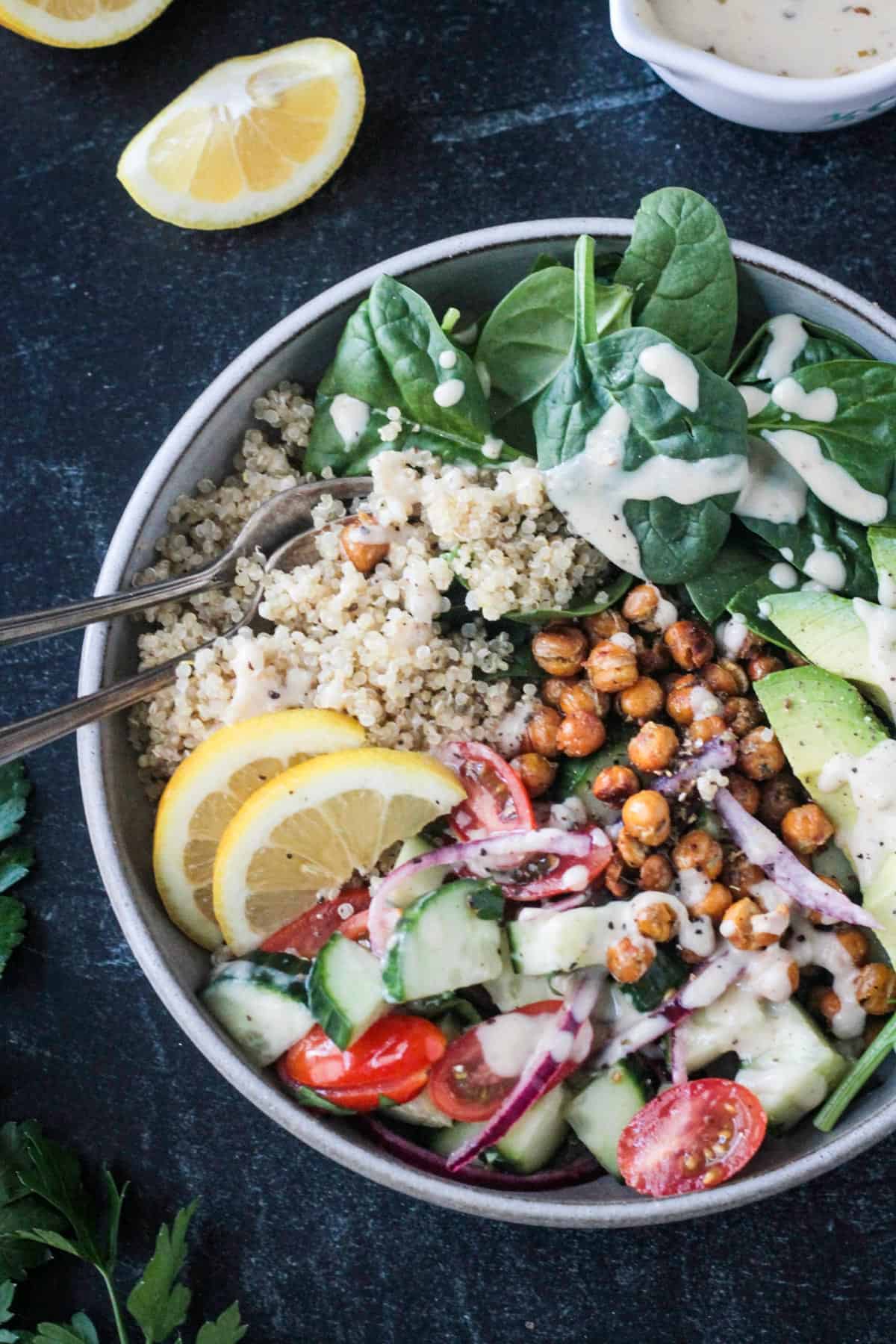 Close up of quinoa and cucumber tomato salad in a dish.