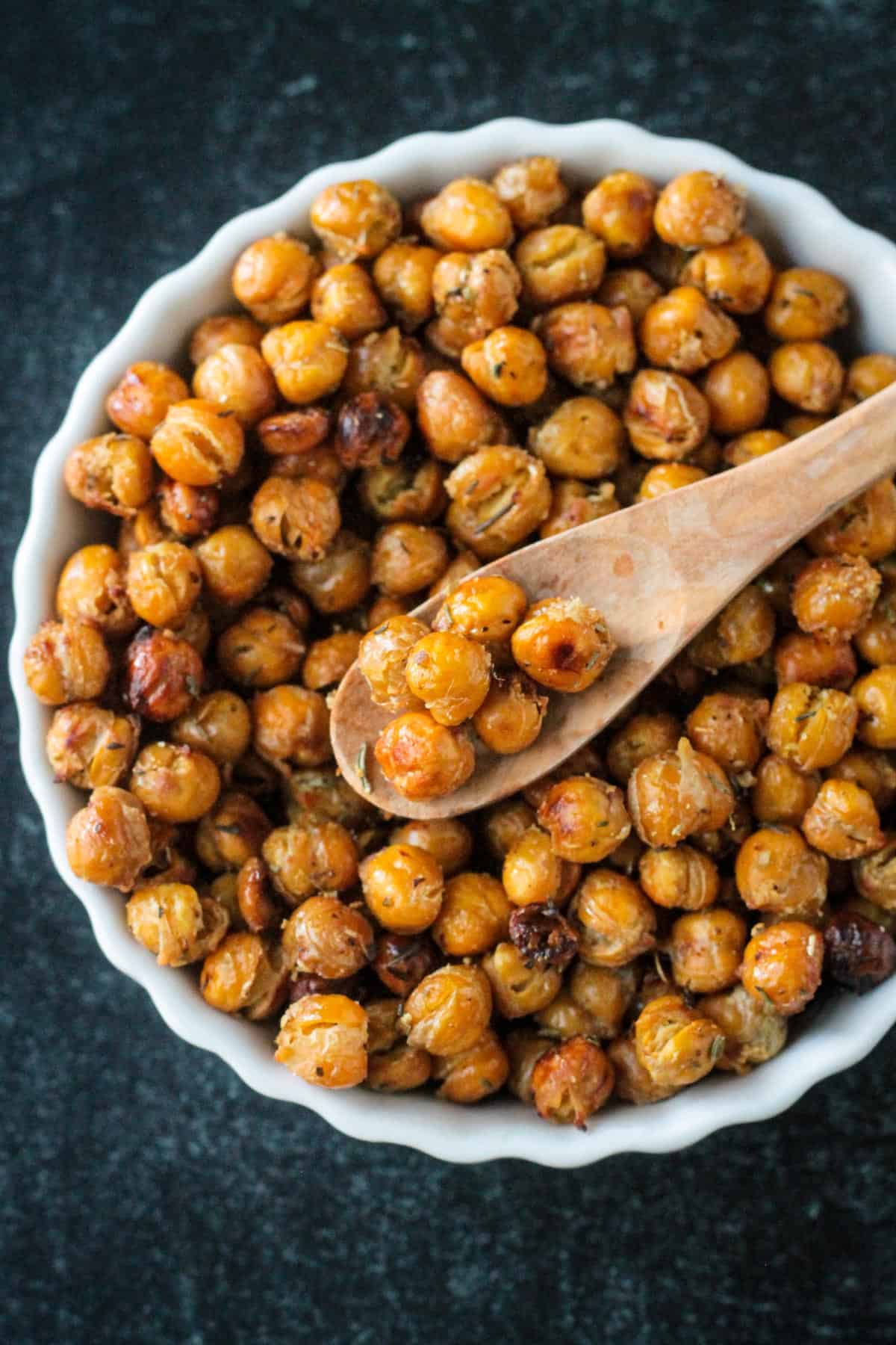 Close up of crispy roasted chickpeas on a spoon.
