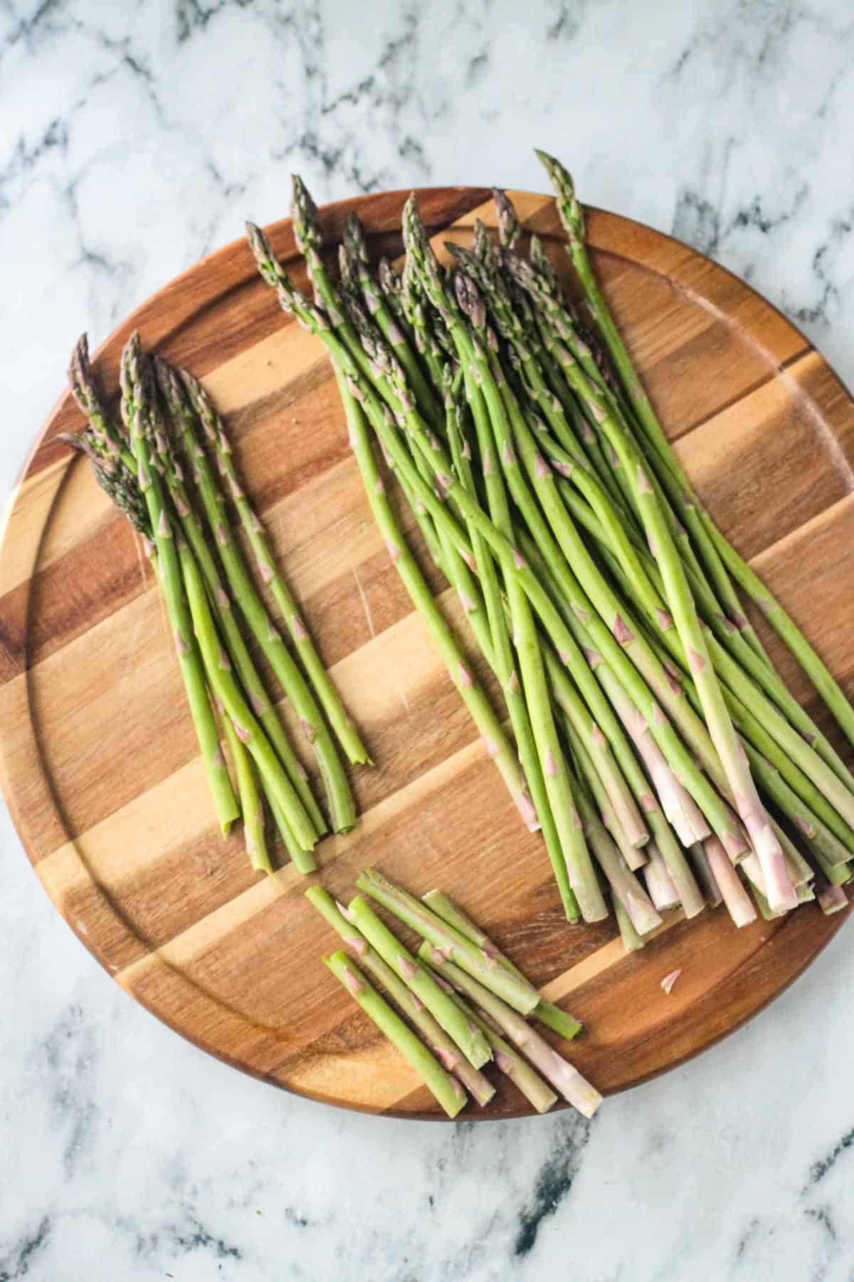 The woody ends of asparagus spears being snapped off.
