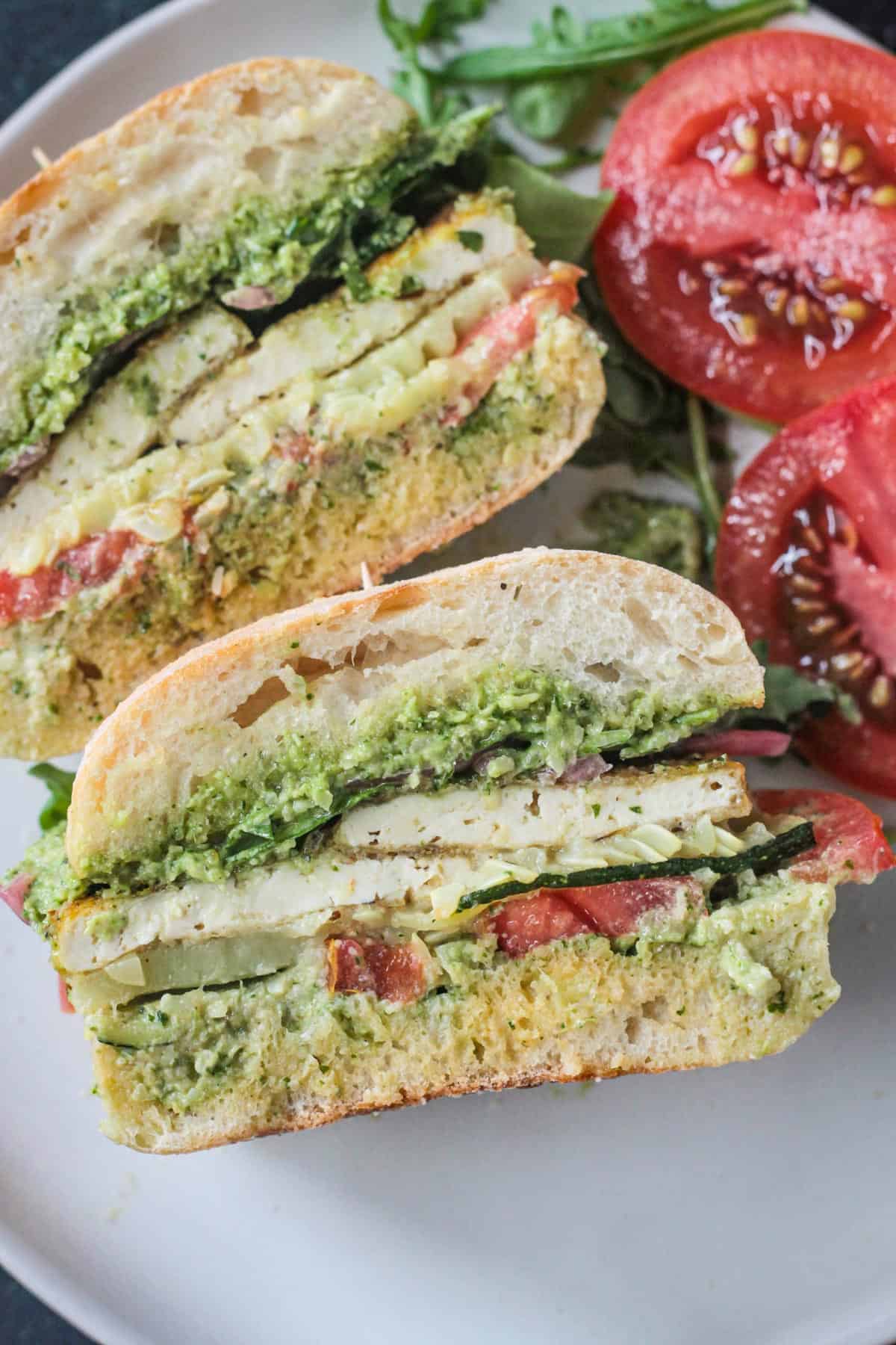 Close up of half of a pesto tofu sandwich.