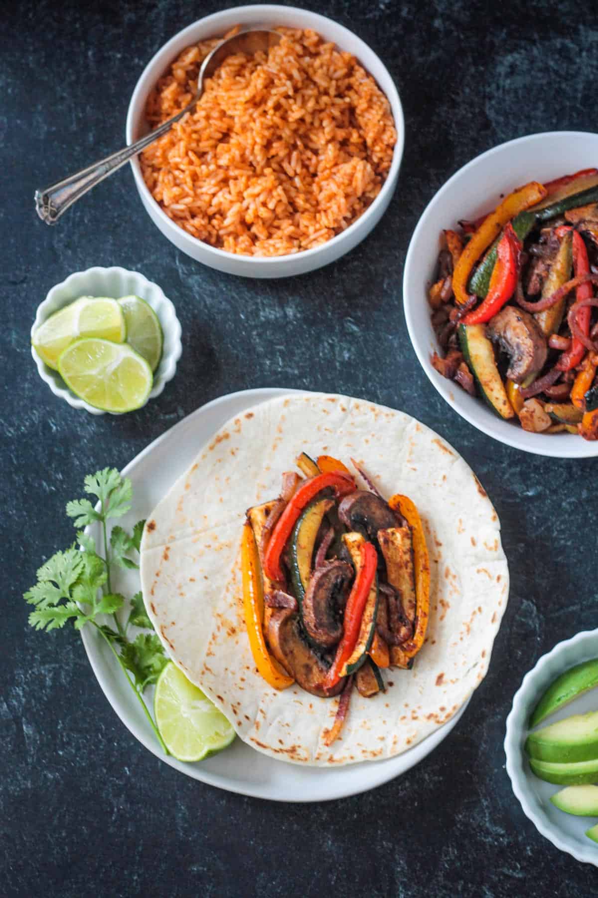 Fajita veggies in a flour tortilla on a plate.