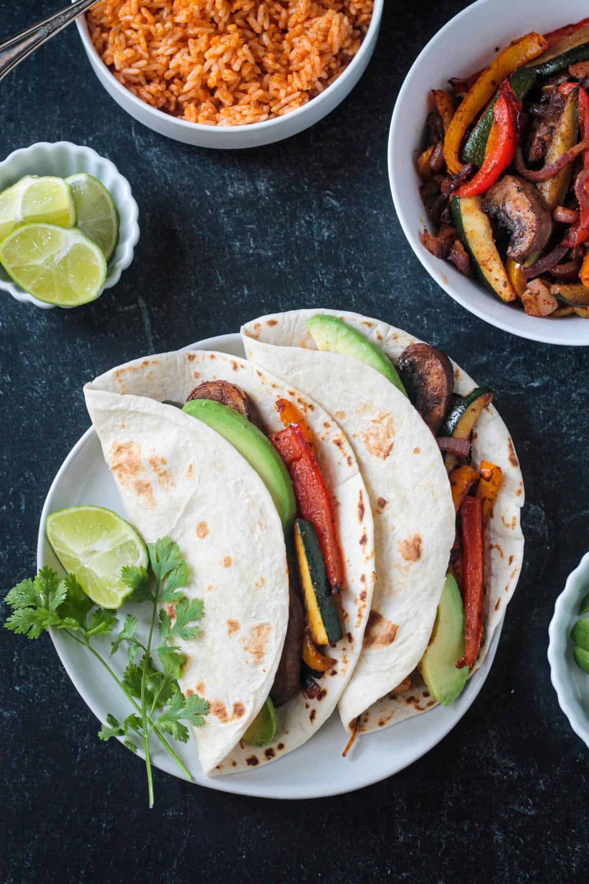 Two vegetable fajitas on a plate.