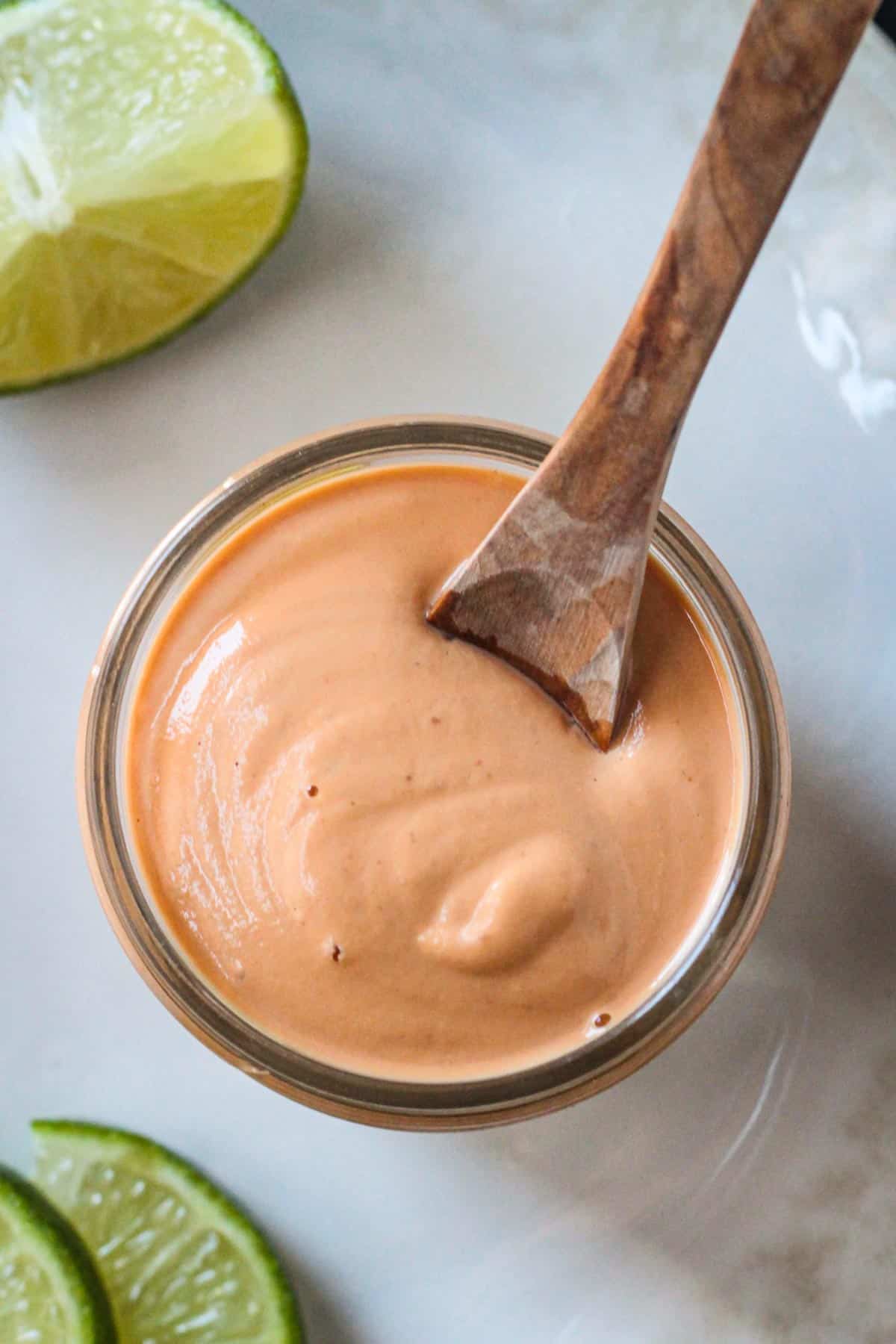 Small glass jar of creamy vegan chipotle crema.