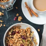 Bowl of pumpkin spice granola with a spoon.