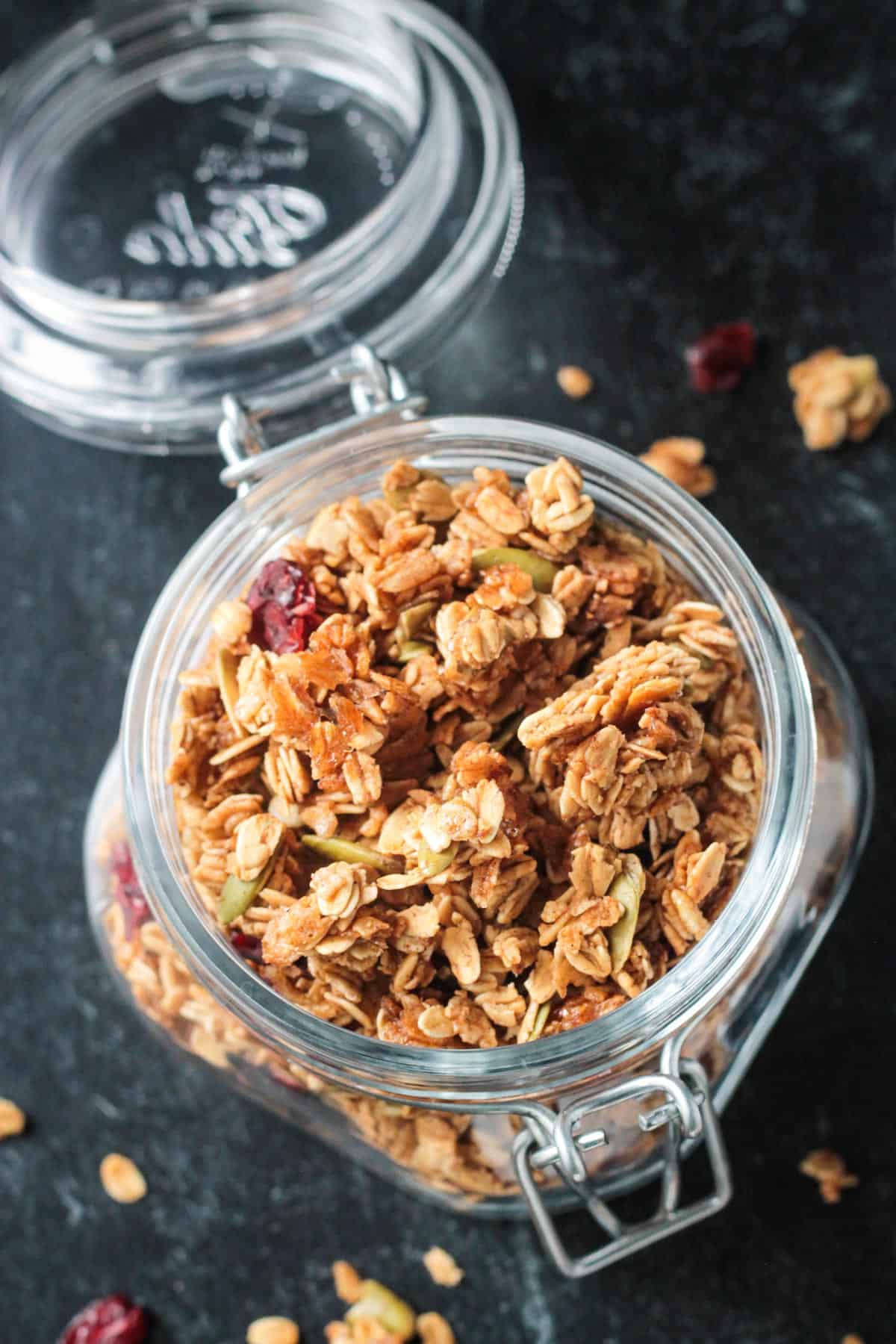 Overhead view of an open jar filled with pumpkin spice granola.