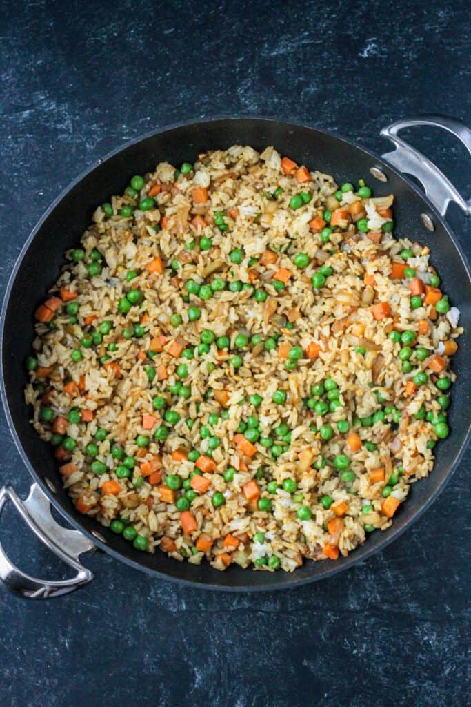 Peas and carrots mixed with rice and seasonings.
