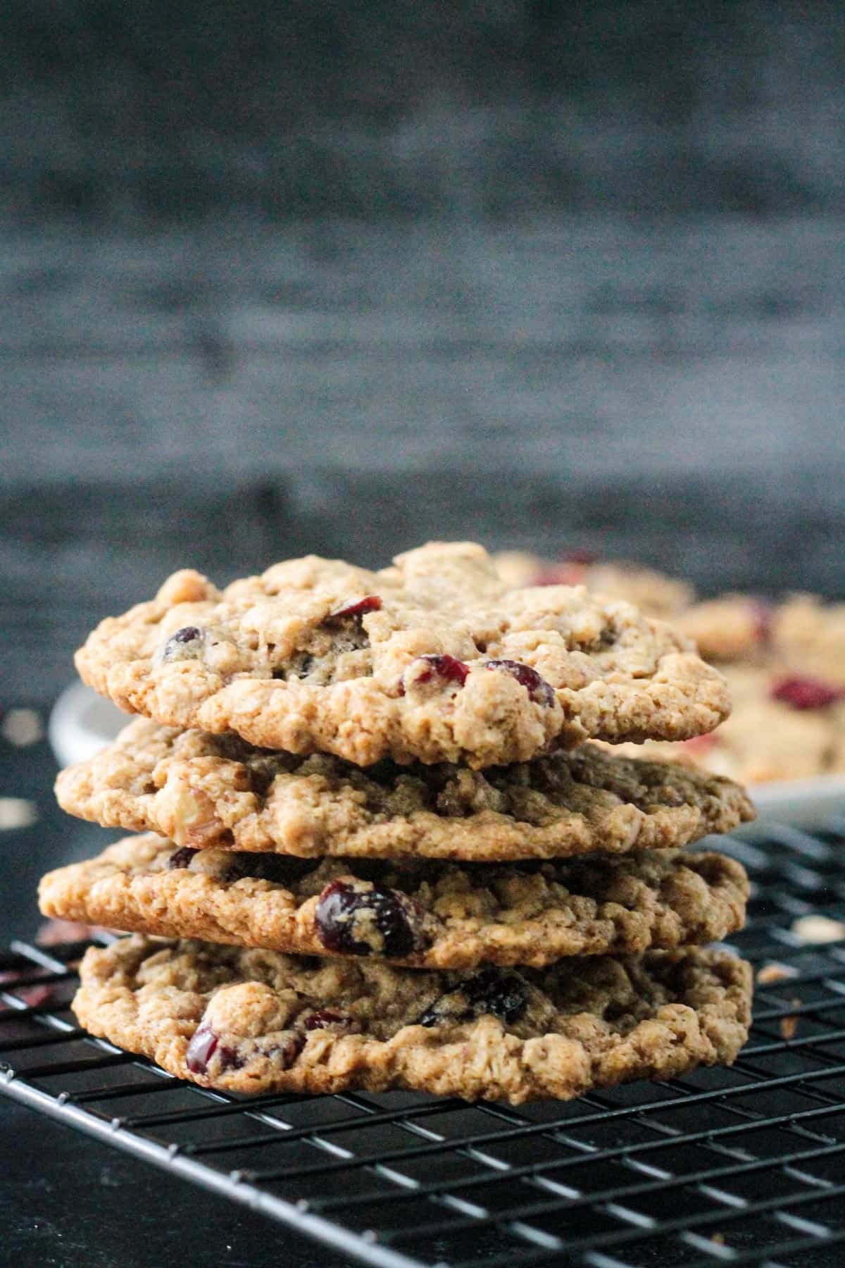 Front view of a stack of four oatmeal cookies with cranberries.