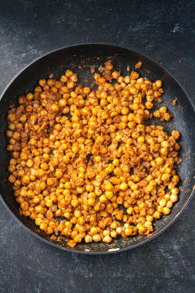 Chickpeas added to the spiced onion mixture.