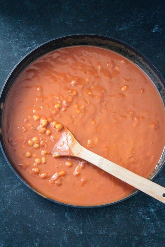 Tomato sauce added to the spiced chickpeas.