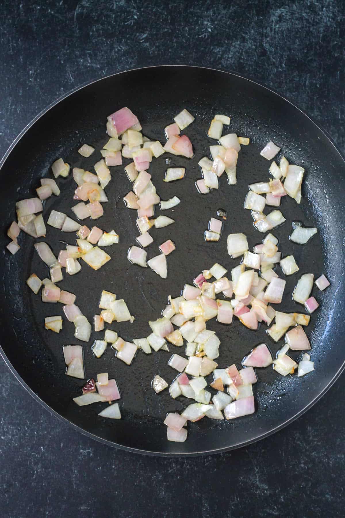 Sautéed onions in a skillet.