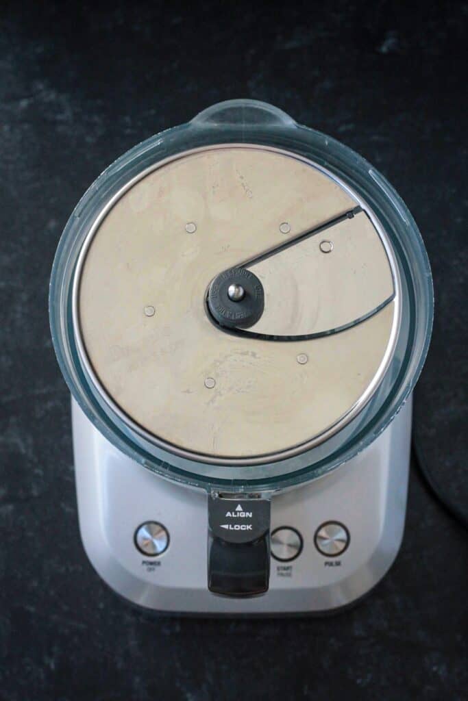 Food processor with a slicing blade attached.