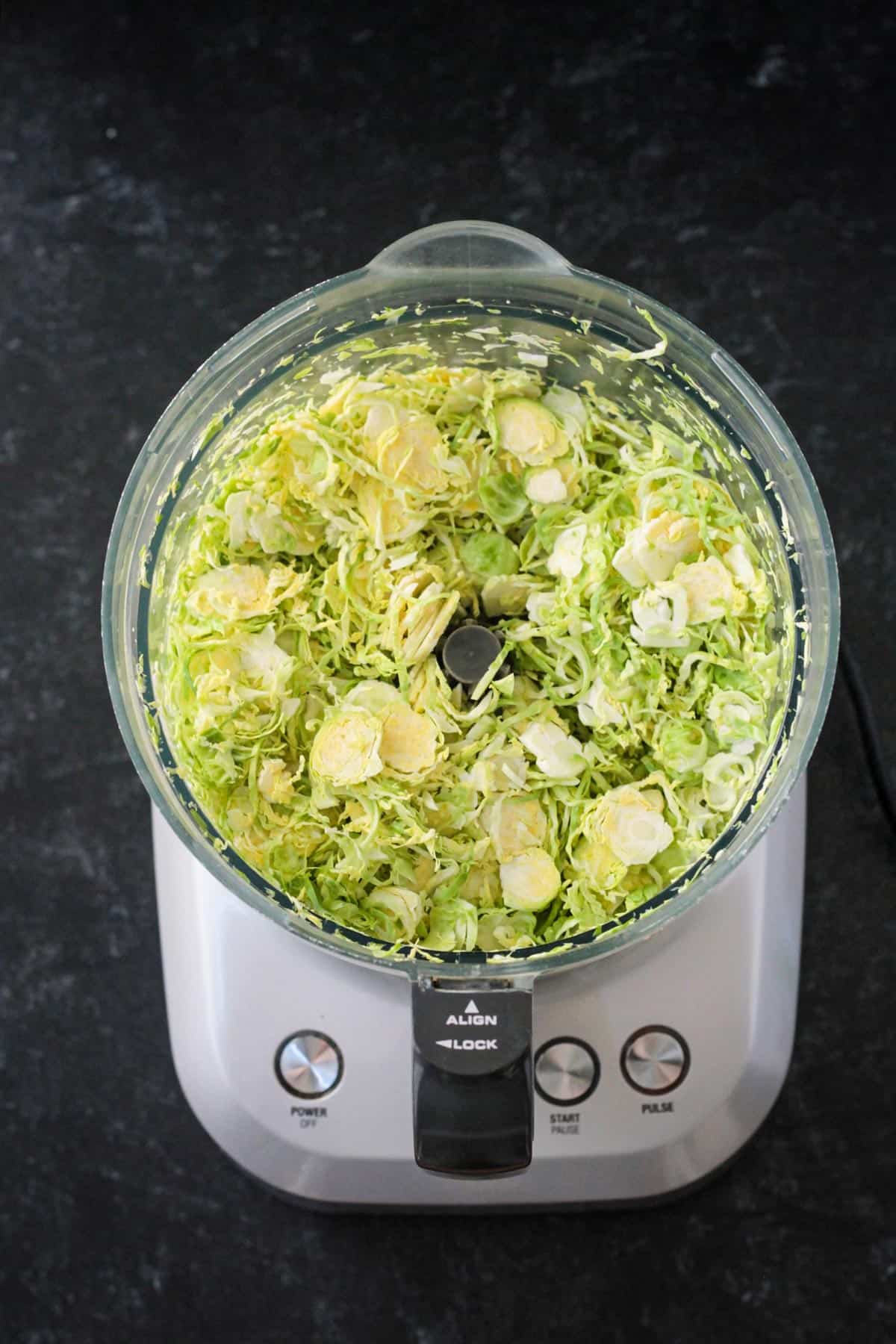 Shaved brussels sprouts in a food processor.