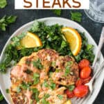 One roasted cauliflower steak garnished with spicy yogurt sauce and chopped parsley on a plate with kale salad and tomatoes.
