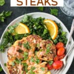 One roasted cauliflower steak garnished with spicy yogurt sauce and chopped parsley on a plate with kale salad and tomatoes.