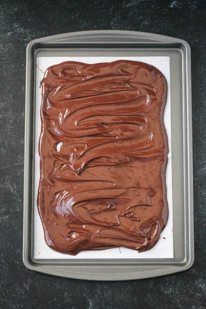 Melted chocolate spread onto a parchment lined baking sheet.