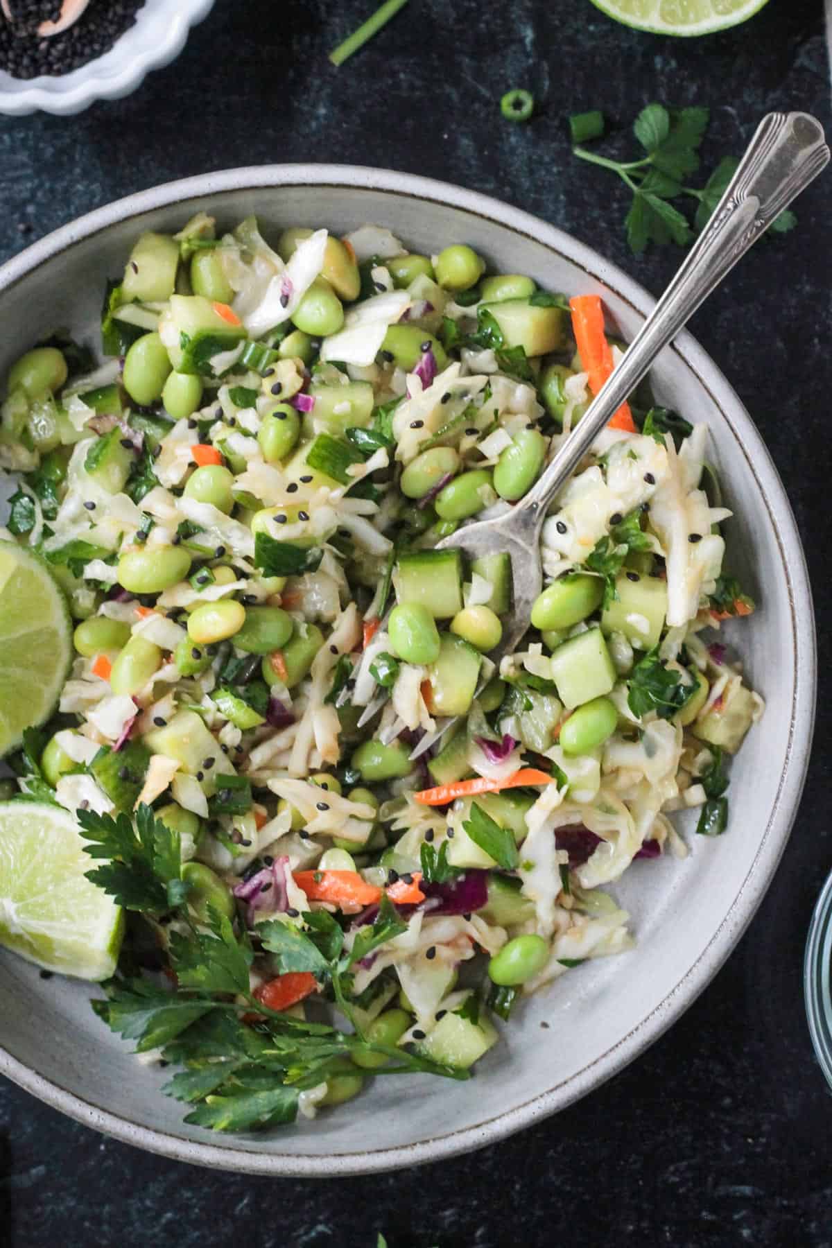 Edamame salad on a plate with a fork.