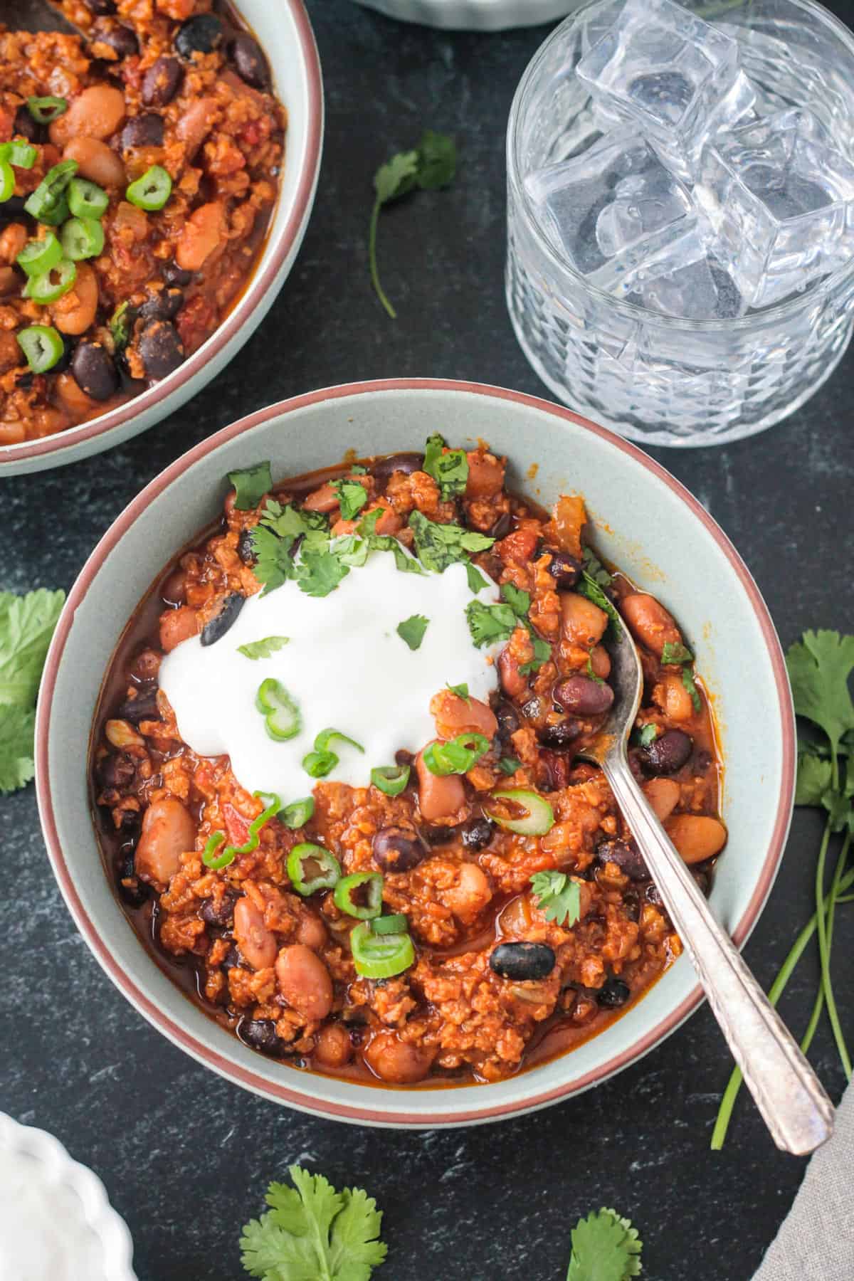 Metal spoon in a bowl of vegan chili.