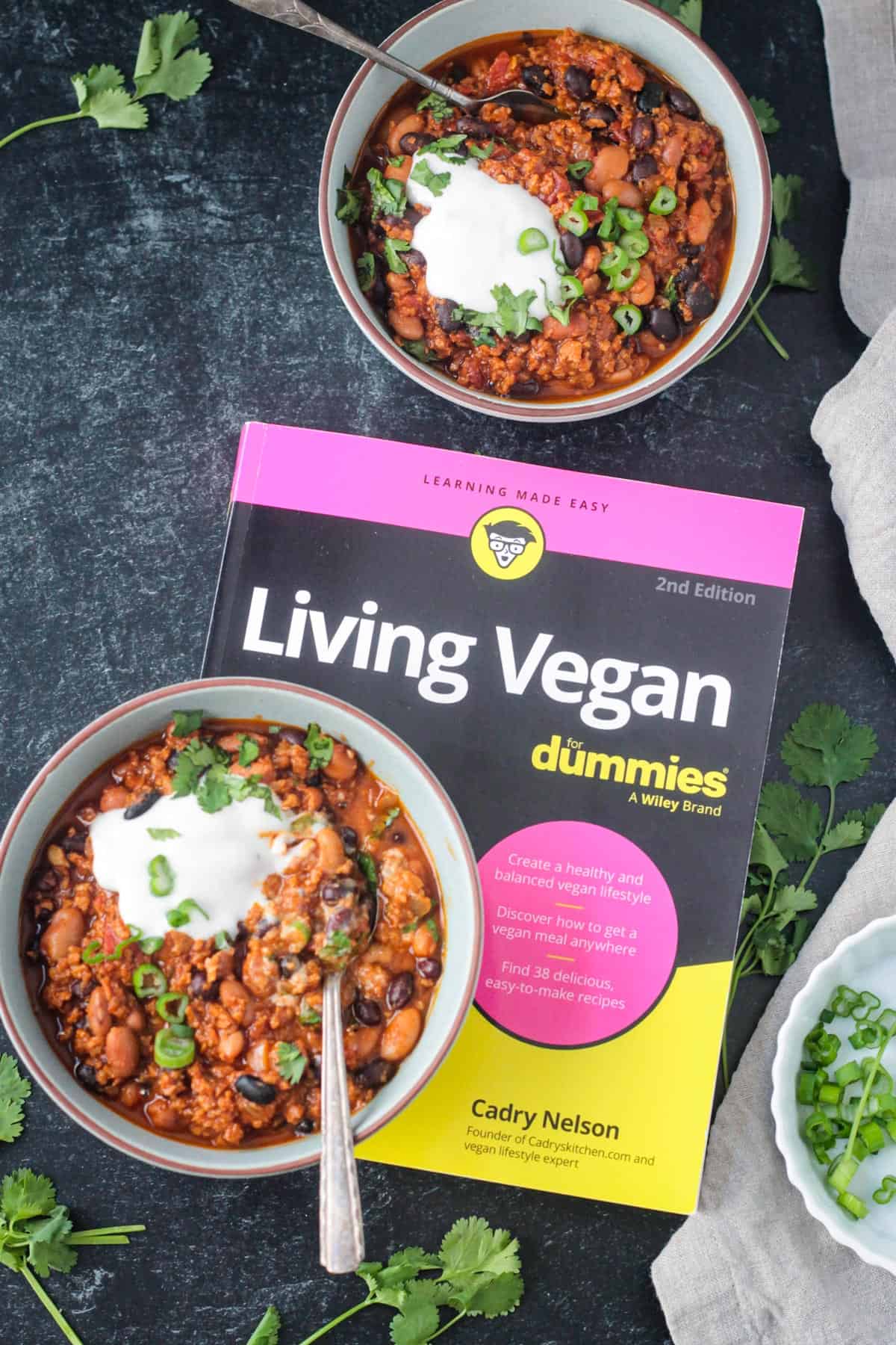 Living Vegan book next to two bowls of chorizo chili.