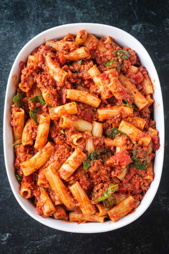 Pasta and sauce combined in a baking dish.