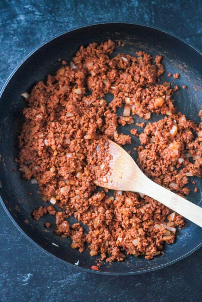 Crumbled soy chorizo combined with the onions and tomato paste.