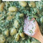 Close up for gnocchi in a creamy spinach cream sauce.