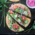 One hummus veggie flatbread cut into three slices.