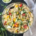 Pepperoncini Pasta Salad in a large bowl with fresh parsley scattered around the bowl.