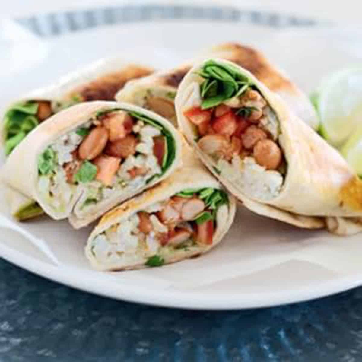Rice and bean burrito cut in half.